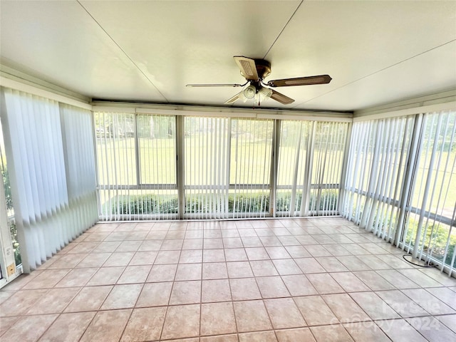 unfurnished sunroom featuring ceiling fan and a wealth of natural light