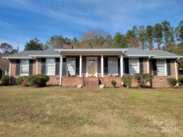 ranch-style home with a porch and a front lawn