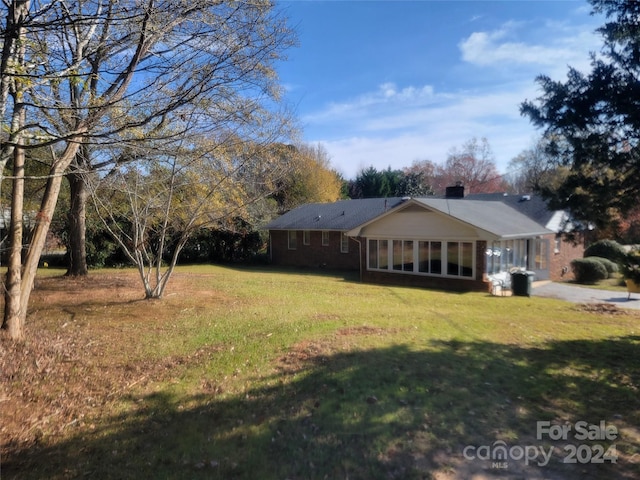 view of yard featuring a sunroom