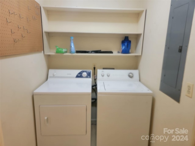 washroom with electric panel and washer and dryer