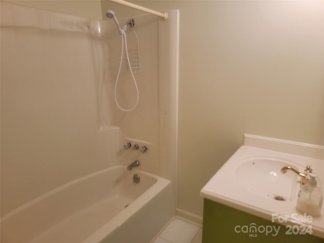 bathroom with tile patterned flooring, vanity, and shower / bath combination