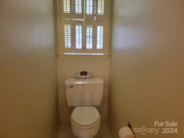 bathroom featuring tile patterned flooring and toilet