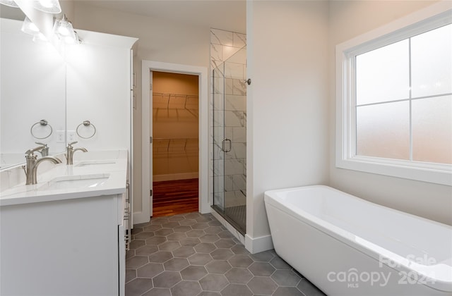 bathroom featuring tile patterned floors, plenty of natural light, shower with separate bathtub, and vanity