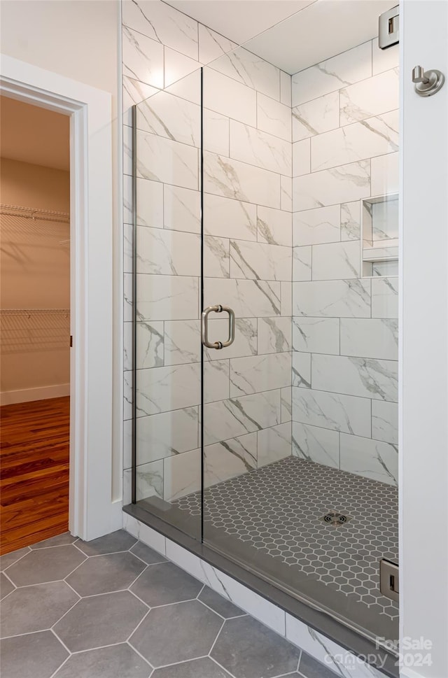 bathroom featuring hardwood / wood-style floors and an enclosed shower