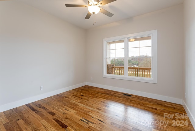 unfurnished room featuring hardwood / wood-style flooring and ceiling fan