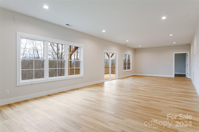 unfurnished room with light wood-type flooring