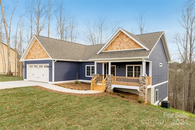 view of front facade with a porch, central AC, a front lawn, and a garage