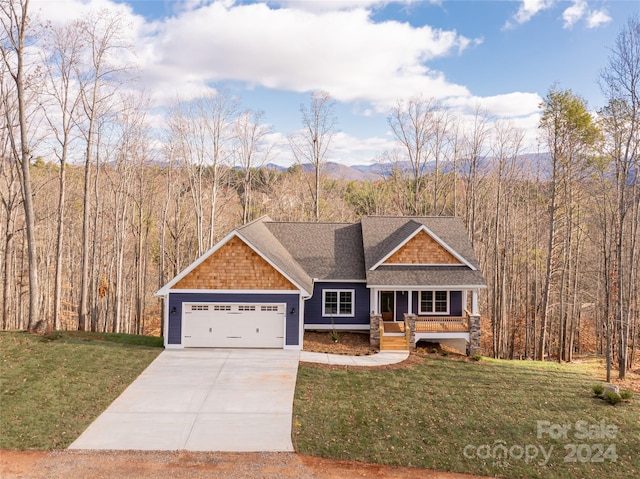 craftsman-style home with covered porch, a garage, and a front yard