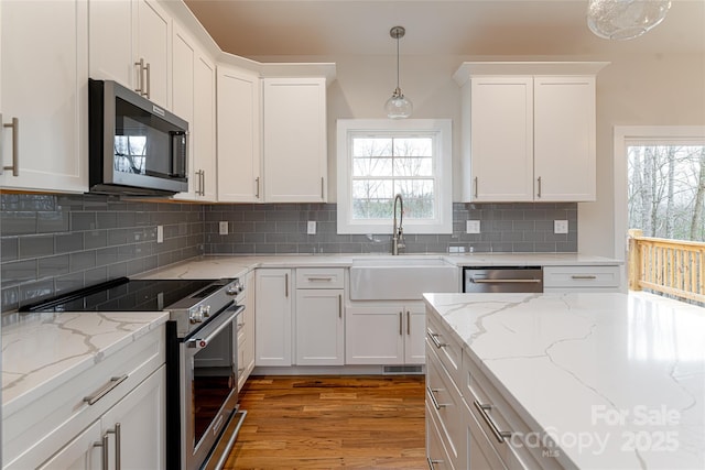 224 Country Dr, Mars Hill, NC 28754 - kitchen featuring stainless steel appliances, white cabinetry, light wood finished floors, and hanging light fixtures
