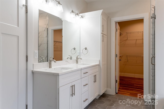 224 Country Dr, Mars Hill, NC 28754 - bathroom with double vanity, a spacious closet, and tile patterned flooring