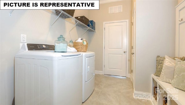 washroom featuring separate washer and dryer and light tile patterned flooring