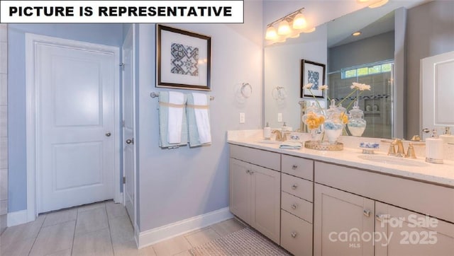 bathroom featuring a shower with door, vanity, and tile patterned floors