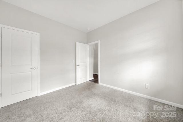 unfurnished bedroom featuring dark colored carpet