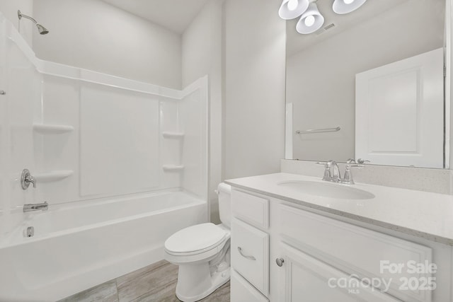 full bathroom with toilet, vanity, and tub / shower combination