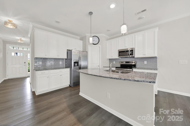 kitchen featuring white cabinets, appliances with stainless steel finishes, sink, and a kitchen island with sink