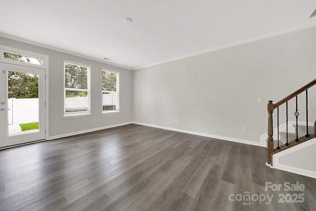 empty room featuring dark hardwood / wood-style floors and ornamental molding