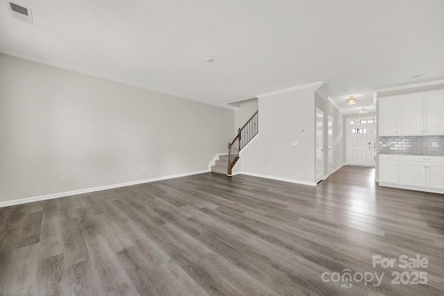 unfurnished living room featuring dark wood-type flooring and crown molding