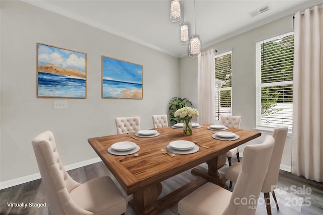 dining space featuring dark wood-type flooring and ornamental molding