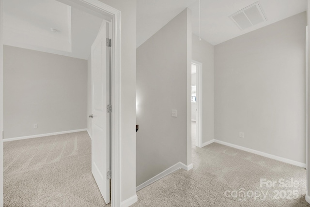 hallway featuring light colored carpet