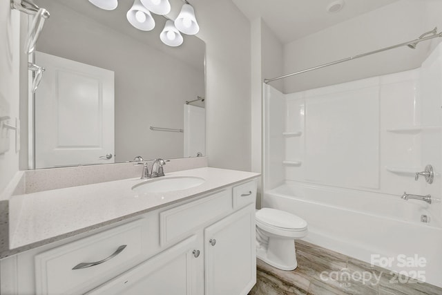 full bathroom with shower / bathtub combination, hardwood / wood-style floors, toilet, and vanity