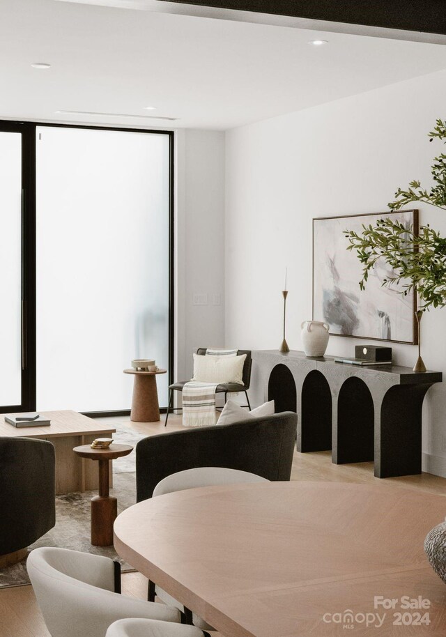 interior space featuring a wealth of natural light and a wall of windows