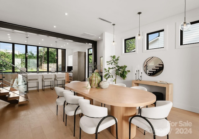 dining room with a healthy amount of sunlight and light hardwood / wood-style flooring