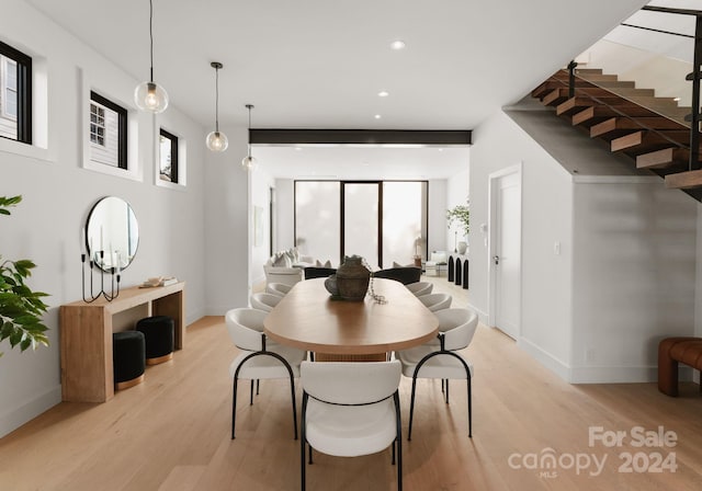 dining space featuring a wealth of natural light and light hardwood / wood-style flooring