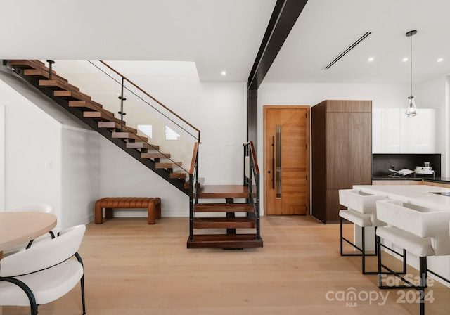 stairway with hardwood / wood-style flooring