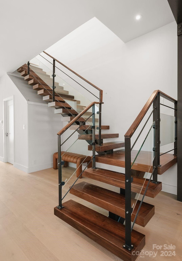 stairs with hardwood / wood-style flooring