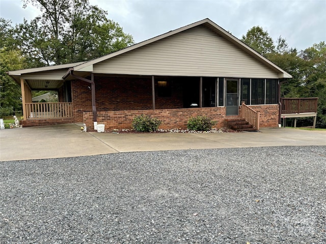 view of front facade with a sunroom and a carport