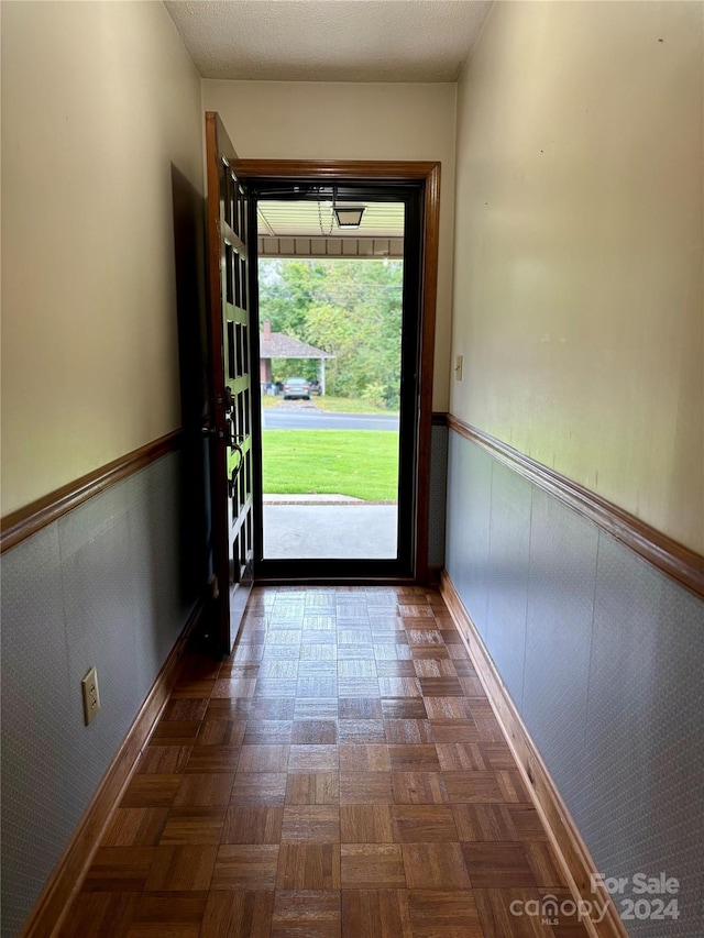 doorway with dark parquet floors