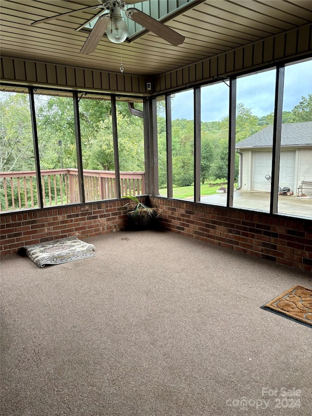 unfurnished sunroom with ceiling fan