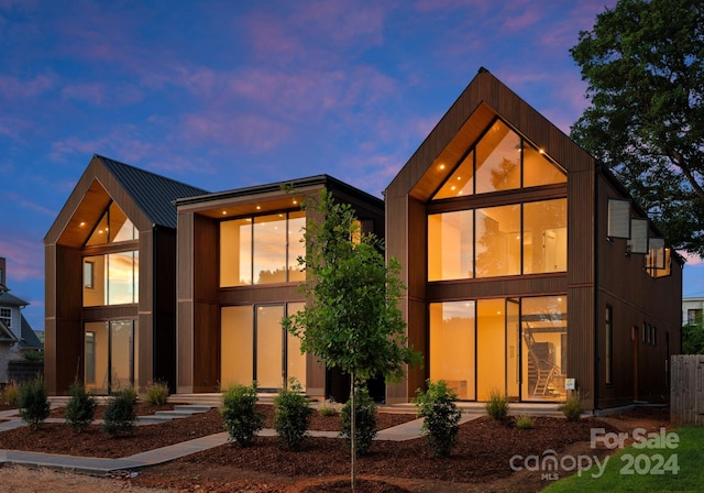 view of back house at dusk