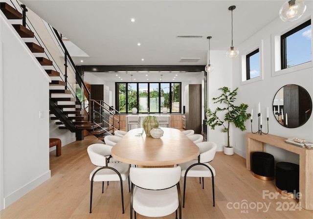 dining space with light hardwood / wood-style floors