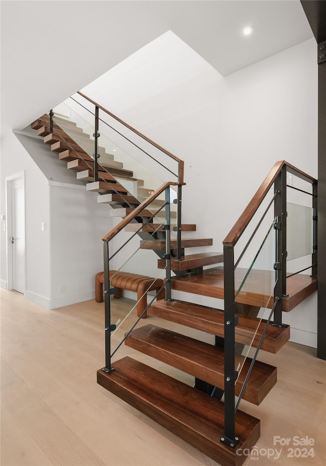 staircase with hardwood / wood-style flooring