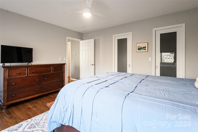 bedroom with ceiling fan and dark wood-type flooring