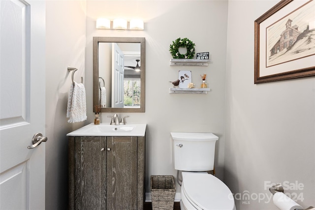 bathroom featuring ceiling fan, vanity, and toilet