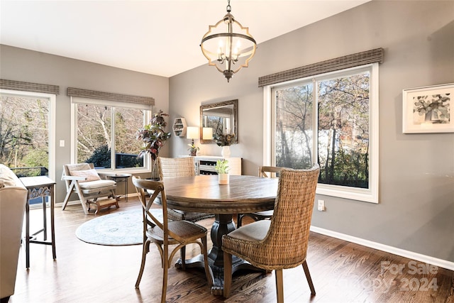 dining space featuring dark hardwood / wood-style floors and a notable chandelier