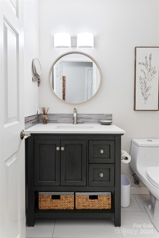 bathroom with tile patterned floors, vanity, and toilet