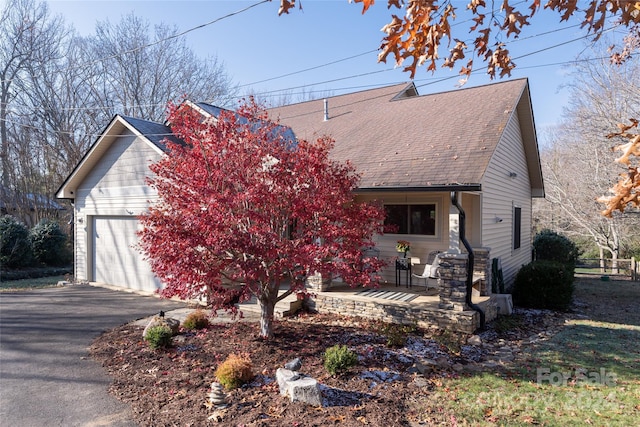 view of front of property with covered porch and a garage