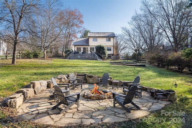 exterior space with a fire pit, a patio area, and a wooden deck