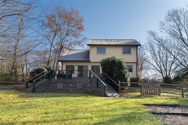 back of house featuring a yard and a wooden deck