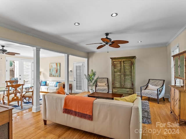 living room with ornamental molding, ceiling fan, light hardwood / wood-style flooring, and ornate columns