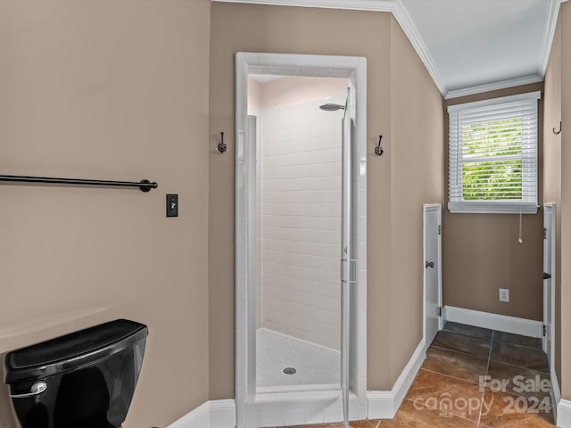 bathroom featuring crown molding, tile patterned flooring, toilet, and a shower with shower door