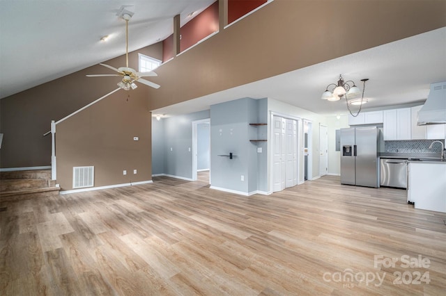 unfurnished living room with ceiling fan with notable chandelier, sink, high vaulted ceiling, and light hardwood / wood-style flooring