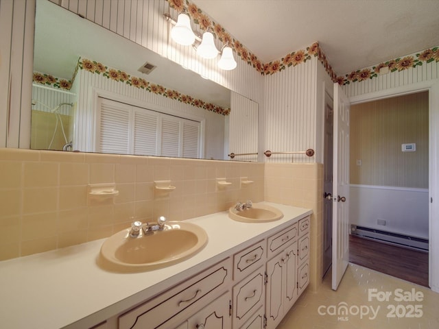 bathroom featuring vanity, a baseboard heating unit, tile walls, and tile patterned floors