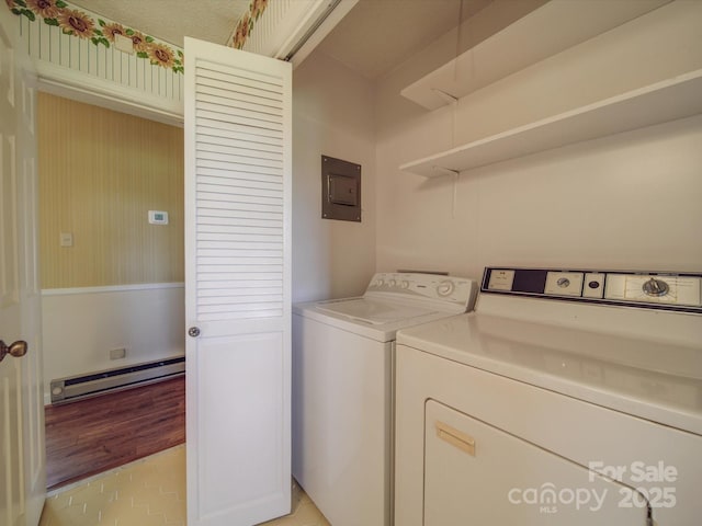 laundry room featuring baseboard heating, electric panel, washing machine and dryer, and light tile patterned floors