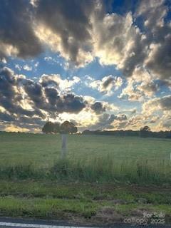 nature at dusk featuring a rural view