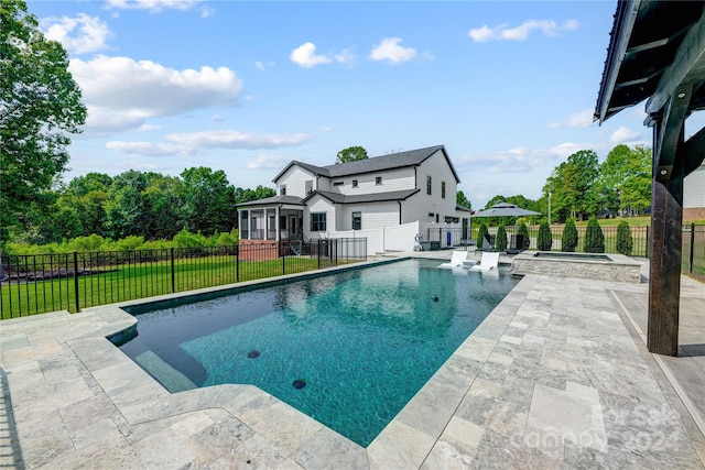 view of pool with a lawn, an in ground hot tub, and a patio