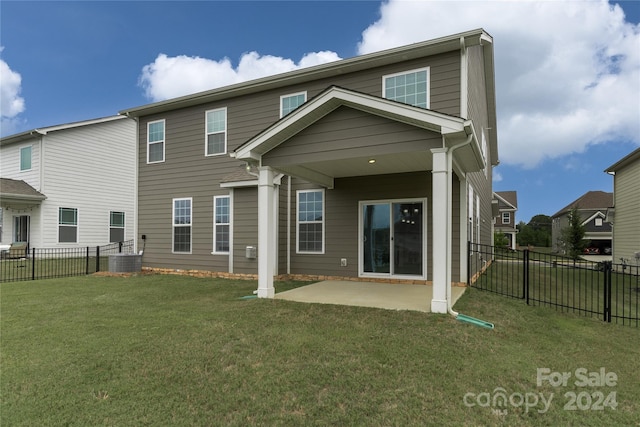 back of house featuring central AC, a patio area, and a yard